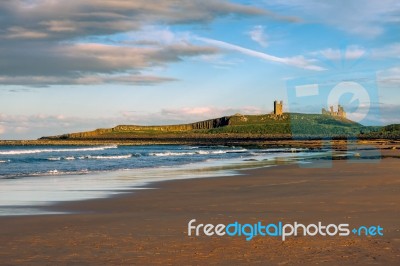 Sunset Over Dunstanburgh Castle Stock Photo