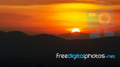 Sunset Over Mountain Range Stock Photo