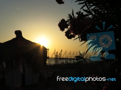 Sunset With Pavilion And Flowers Stock Photo