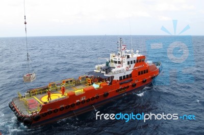 Supply Boat Transfer Cargo To Oil And Gas Industry Stock Photo