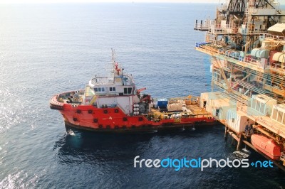 Supply Boat Transfer Cargo To Oil And Gas Industry Stock Photo