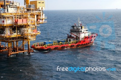  Supply Boat Transfer Cargo To Oil And Gas Industry And Moving Cargo From The Boat To The Platform Stock Photo