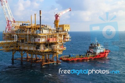  Supply Boat Transfer Cargo To Oil And Gas Industry And Moving Cargo From The Boat To The Platform Stock Photo