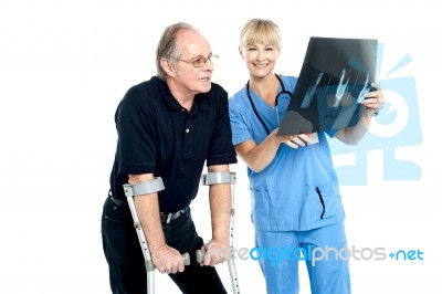 Surgeon Showing X-ray Sheet To Her Patient Stock Photo