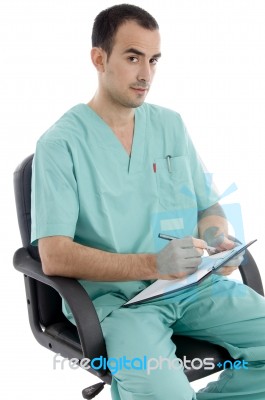 surgeon writing on clipboard Stock Photo