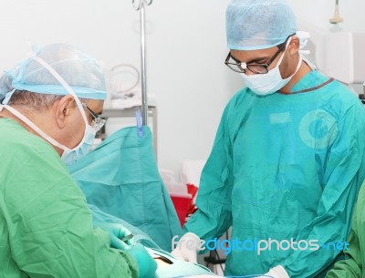 Surgeons Working In Operation Room Stock Photo