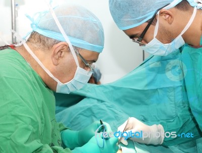 Surgeons Working On A Patient In Operation Room Stock Photo