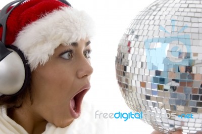 Surprised Woman Looking To Disco Ball And Wearing Christmas Hat Stock Photo