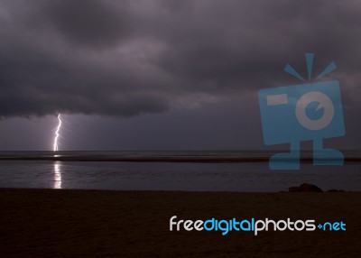 Surreal, Stormy Night Enlightened By Thunder On The Coastline In… Stock Photo