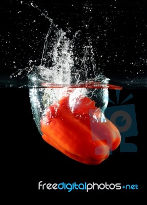 Sweet Pepper Drop Into Water Stock Photo