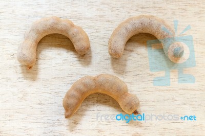 Sweet Ripe Tamarind Pods On Wood Background Stock Photo