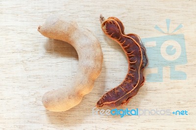 Sweet Ripe Tamarind Pods On Wood Background Stock Photo