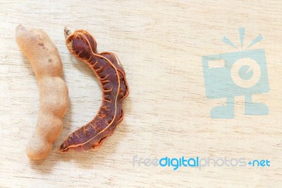 Sweet Ripe Tamarind Pods On Wood Background Stock Photo