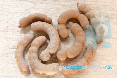 Sweet Ripe Tamarind Pods On Wood Background Stock Photo