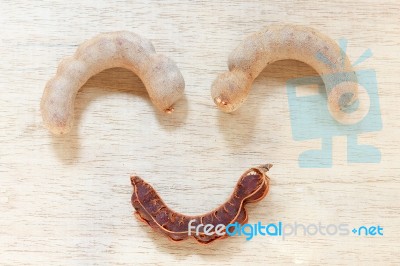 Sweet Ripe Tamarind Pods On Wood Background Stock Photo