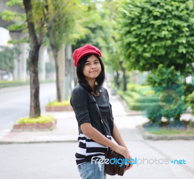 Sweet Young Woman Standing Outdoors And Smiling In Public Park Stock Photo