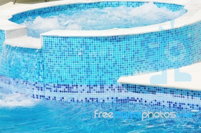 Swimming Pool With Waterfall Jet Stock Photo