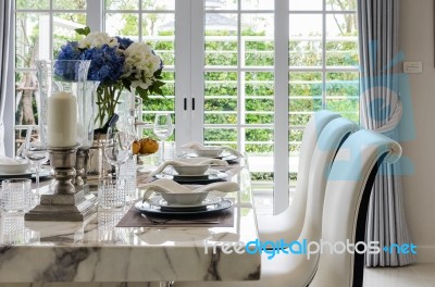 Table Set In White Dinning Room With Chairs Stock Photo