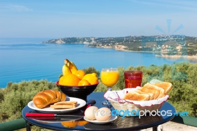 Table With Food And Drinks In Front Of Sea On Island Stock Photo