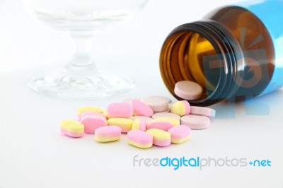 Tablet Medicine From Bottle On Desk Stock Photo