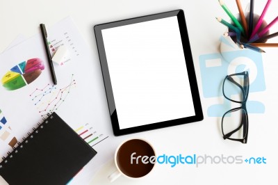 Tablet On Desk Workspace In Office Background Stock Photo