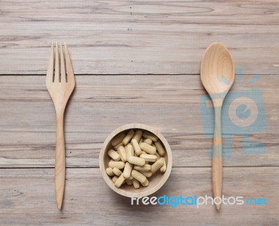 Tablets In Wood Bowl ,spoon On Wooden Background Stock Photo