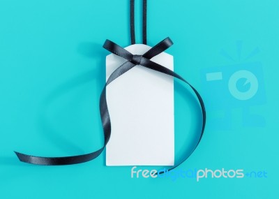 Tag With Ribbon On Blue Stock Photo