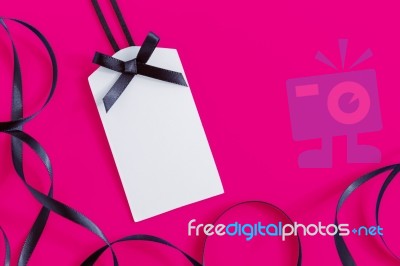 Tag With Ribbon On Pink Stock Photo