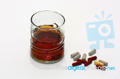 Taking Alcohol And Pills Stock Photo