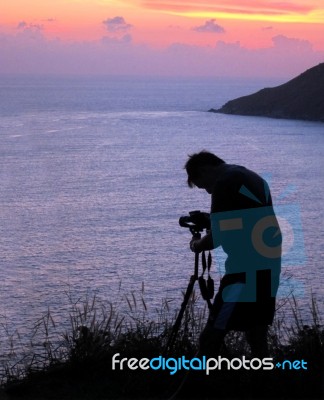 Taking Photograph Of Sunset    Stock Photo