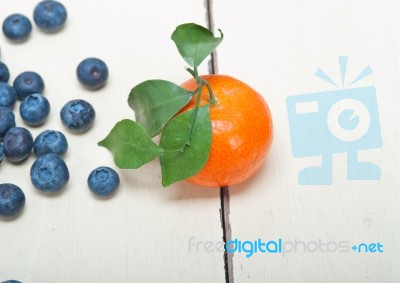 Tangerine And Blueberry On White Table Stock Photo