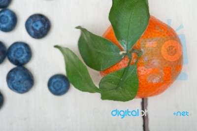 Tangerine And Blueberry On White Table Stock Photo