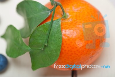 Tangerine And Blueberry On White Table Stock Photo