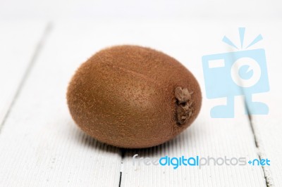 Tasty Kiwi Fruit Isolated On A White Wooden Background Stock Photo