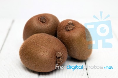 Tasty Kiwi Fruits Isolated On A White Wooden Background Stock Photo