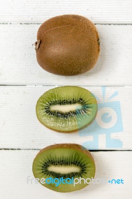 Tasty Kiwi Fruits Isolated On A White Wooden Background Stock Photo