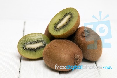 Tasty Kiwi Fruits Isolated On A White Wooden Background Stock Photo