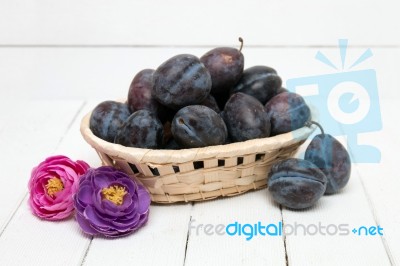 Tasty Purple Plums Isolated On A White Wooden Background Stock Photo