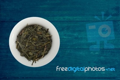 Tea Blendss On Strands In Presenters On Blue Wooden Background Stock Photo