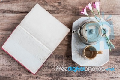 Tea Cups With Teapot With Open Book On Old Wooden Table. Top Vie… Stock Photo