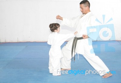 Teacher Training Karate To A Little Girl Stock Photo