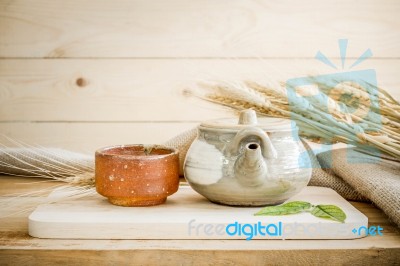 Teapot On Wooden And Sackcloth Background Stock Photo