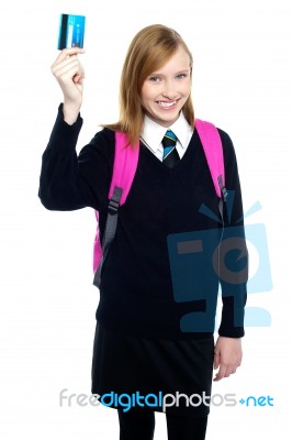 Teen Girl In Uniform Holding Up A Cash Card Stock Photo