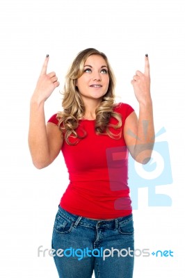 Teen Girl Looking And Indicating Upwards Stock Photo