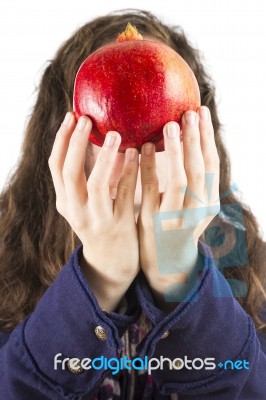 Teen Holding A Pomegranate Stock Photo