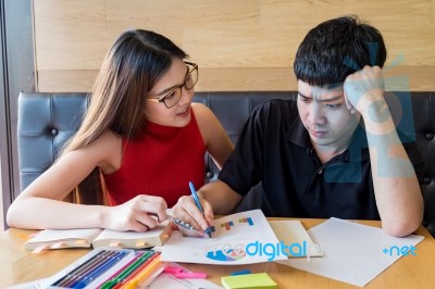 Teenage Boy And Girl Students, Doing Homework Together On A Note… Stock Photo