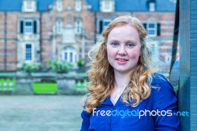 Teenage Girl At Gate Of Castle Stock Photo