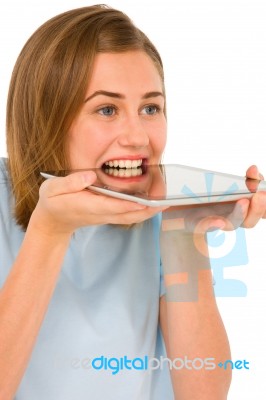 Teenage Girl Biting Tablet Pc Stock Photo