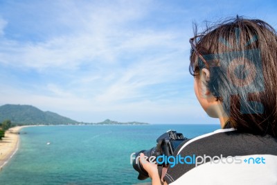 Teenage Girl Is Holding Camera On High Stock Photo