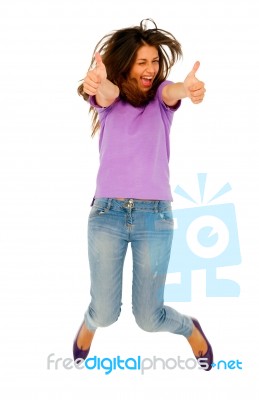 Teenage Girl Jumping With Thumbs Up Stock Photo